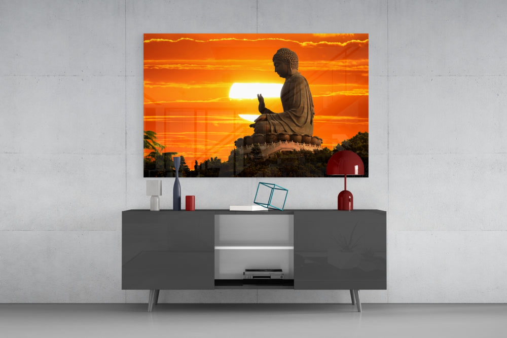 Buddha glass wall art catching light to reveal its painted sunset