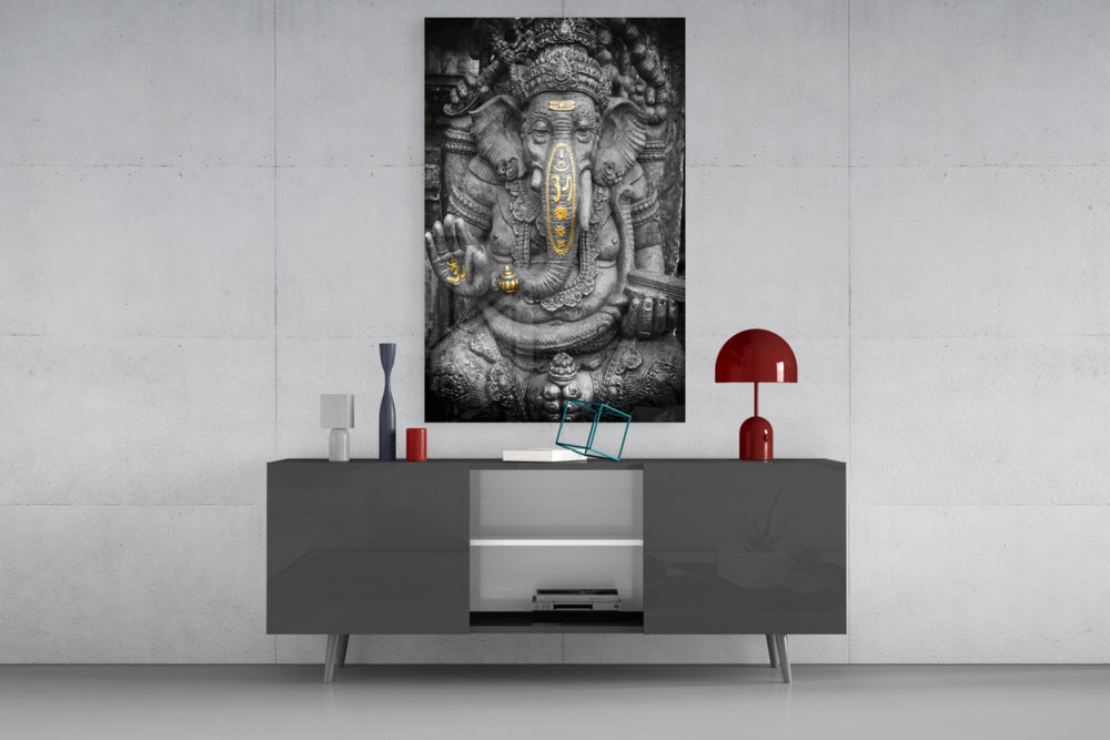 Ganesha glass wall art catching light to reveal its painted gold
