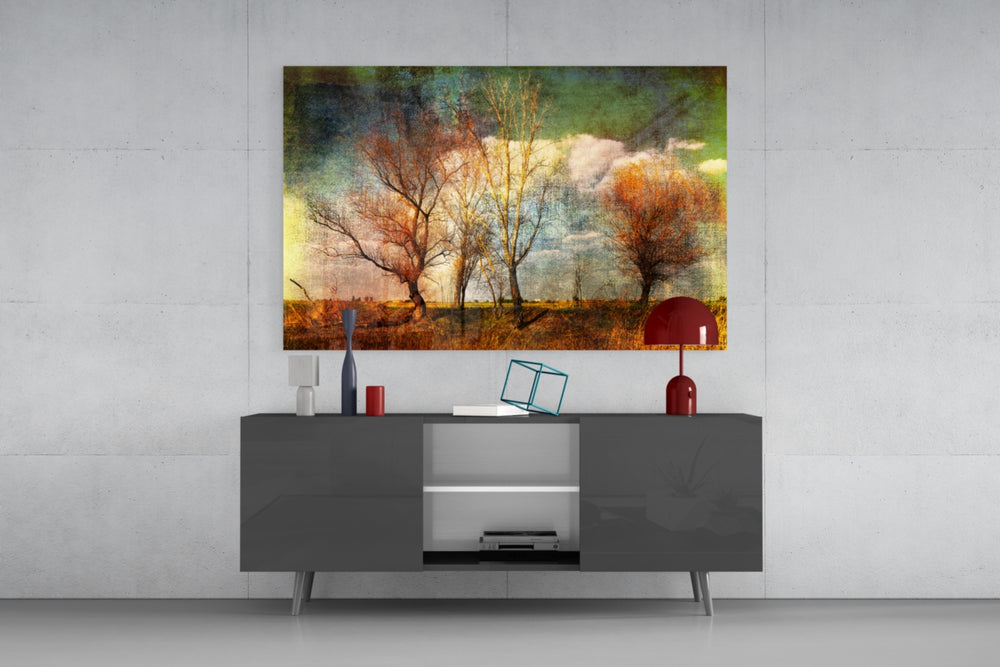 Autumn Trees glass wall art catching light to reveal its painted canvas