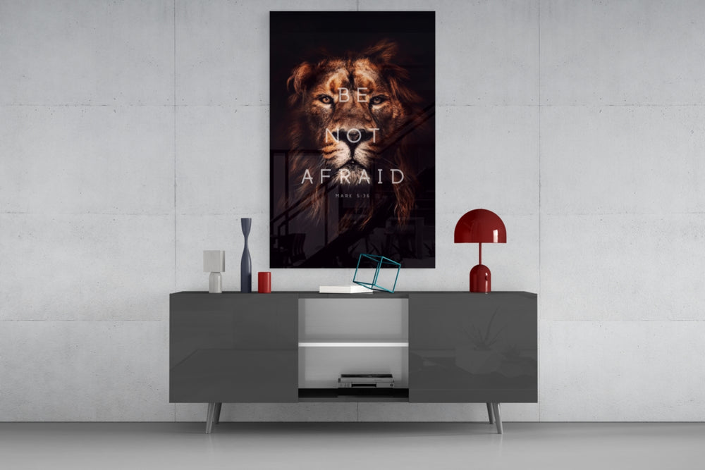Lion glass wall art catching light to reveal its painted typography