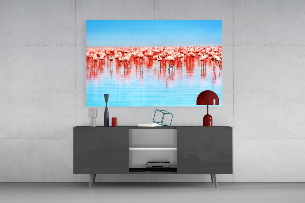 Flamingos glass wall art catching light to reveal its painted reflection