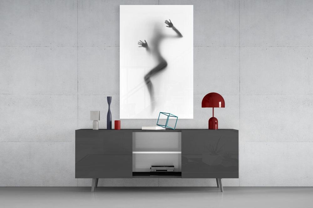 Woman Shadow glass wall art catching light to reveal its painted haze