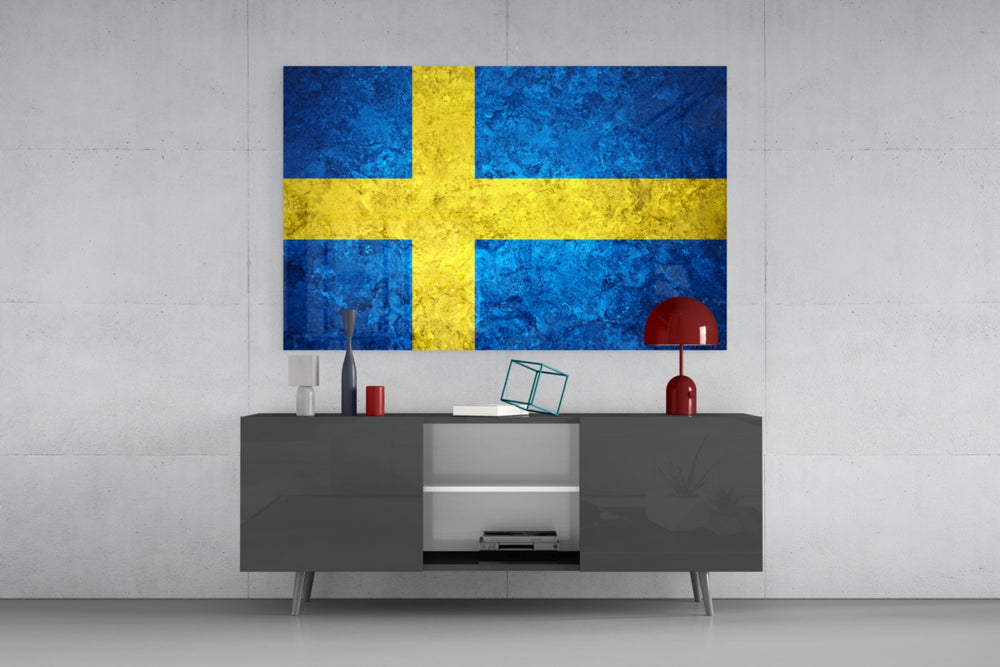Flag of Sweden glass wall art catching light to reveal its painted stone-grunge