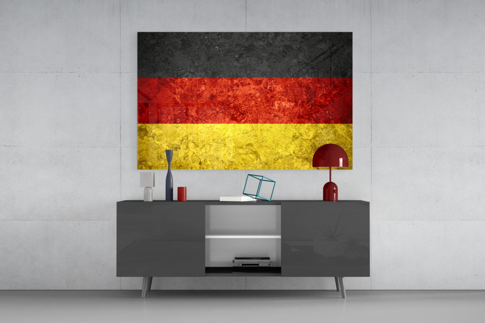Flag of Germany glass wall art catching light to reveal its painted stone-grunge