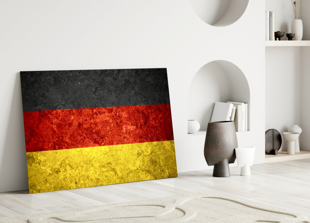 Close-up detail of rough-stone German tricolor behind glass