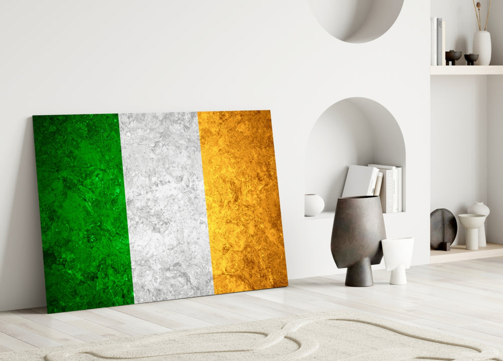 Close-up detail of rough-stone Irish tricolor behind glass