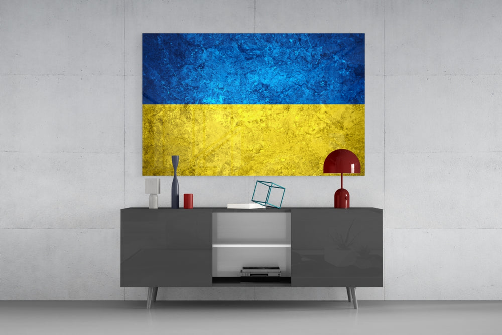 Flag of Ukraine glass wall art catching light to reveal its painted stone-grunge