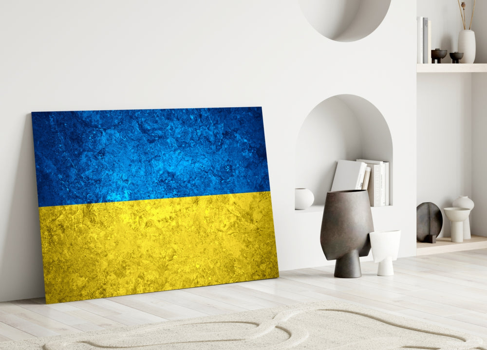 Close-up detail of rough-stone Ukrainian flag behind glass