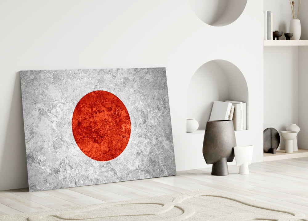 Close-up detail of rough-stone Hinomaru sun-disc behind glass