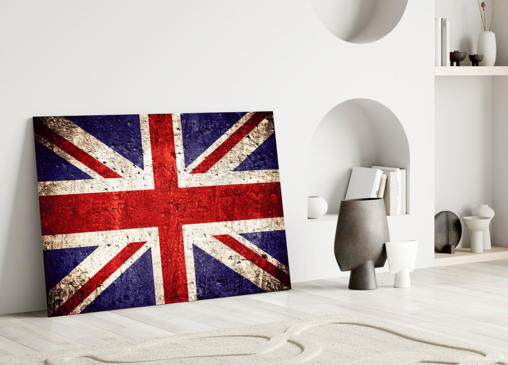 Close-up detail of weathered-concrete Union Jack behind glass