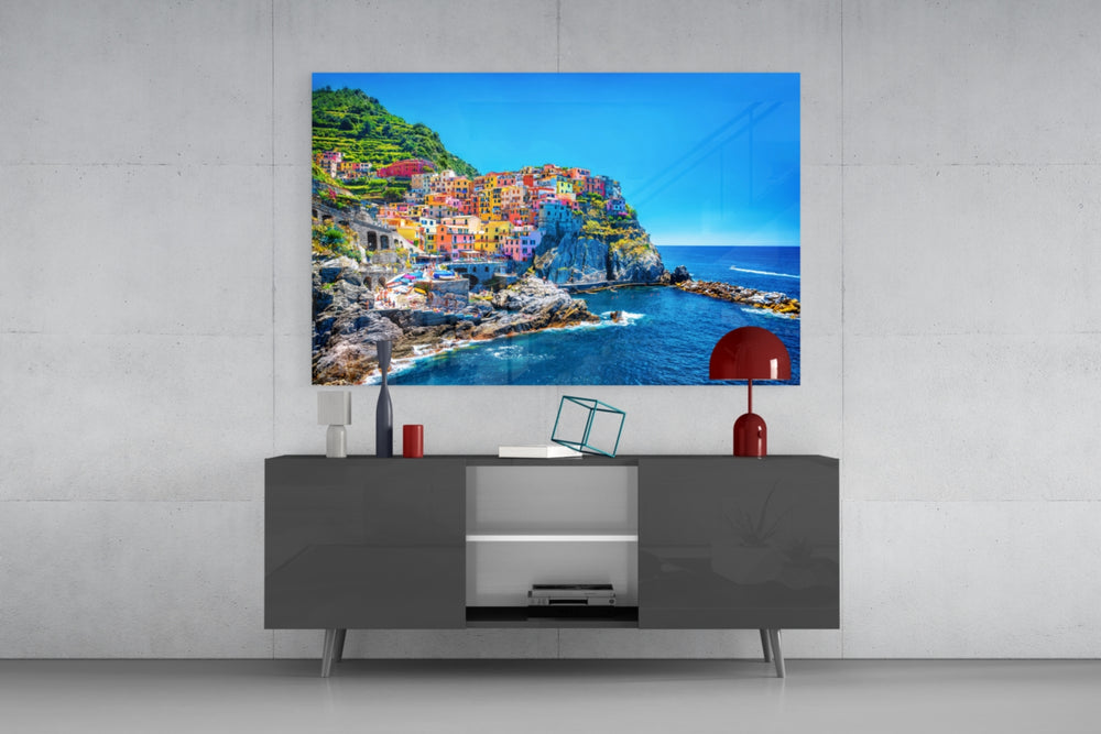 Manarola glass wall art catching light to reveal its painted Riviera tones