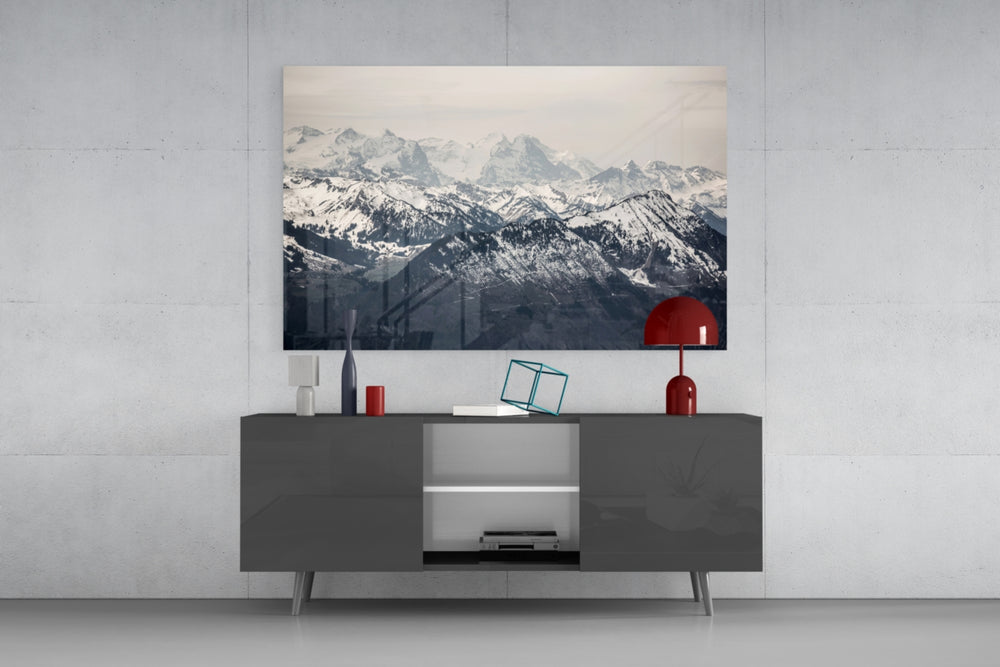 Snowy Mountains glass wall art catching light to reveal its painted ridges