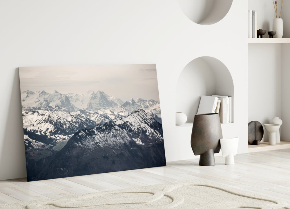 Close-up detail of snowcapped sawtooth peaks behind glass