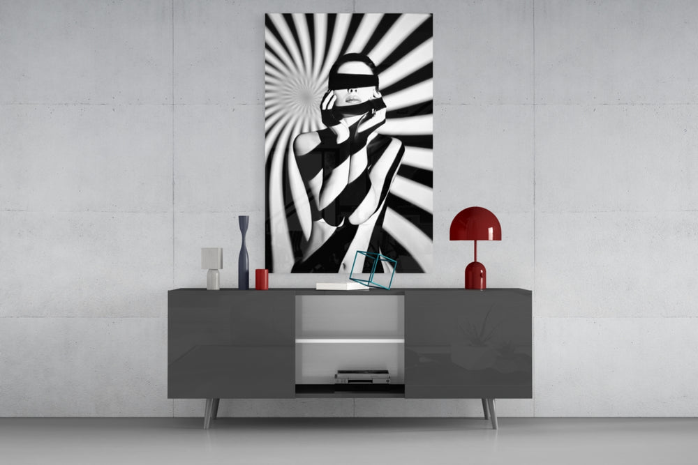 Censored glass wall art catching light to reveal its painted spiral