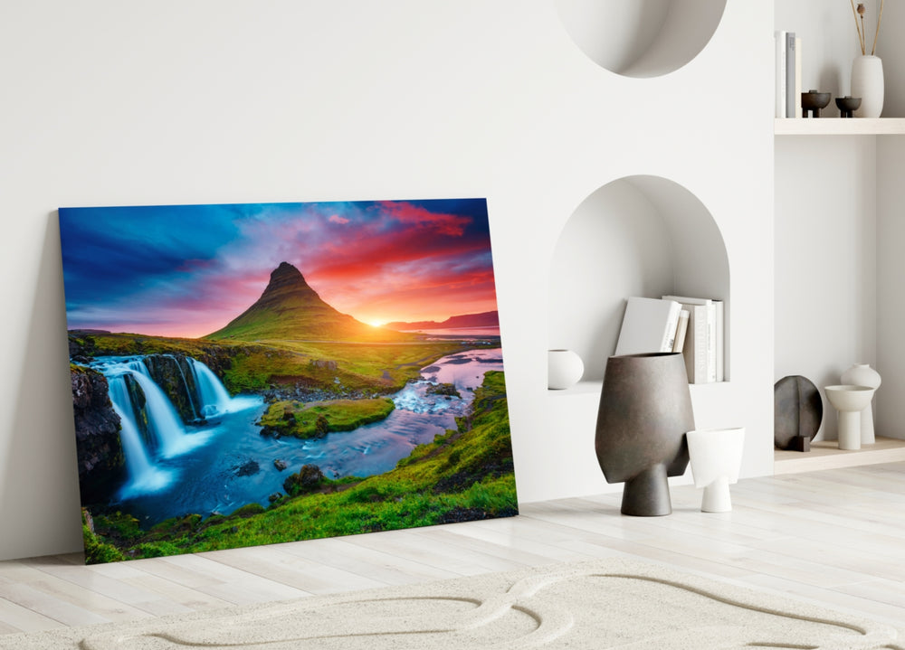 Close-up detail of Kirkjufell silhouette and silken waterfall behind glass