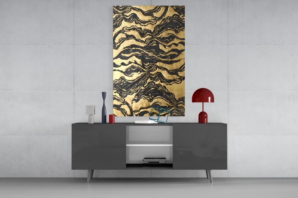 Golden Waves glass wall art catching light to reveal its painted gilded relief