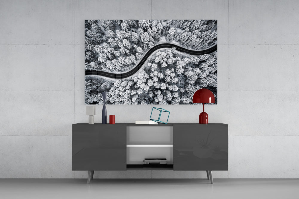 Forest Landscape glass wall art catching light to reveal its painted snow tones