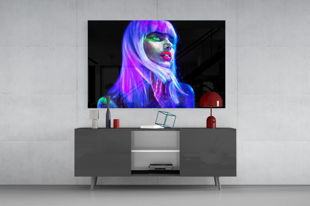 Woman glass wall art catching light to reveal its painted UV pigments