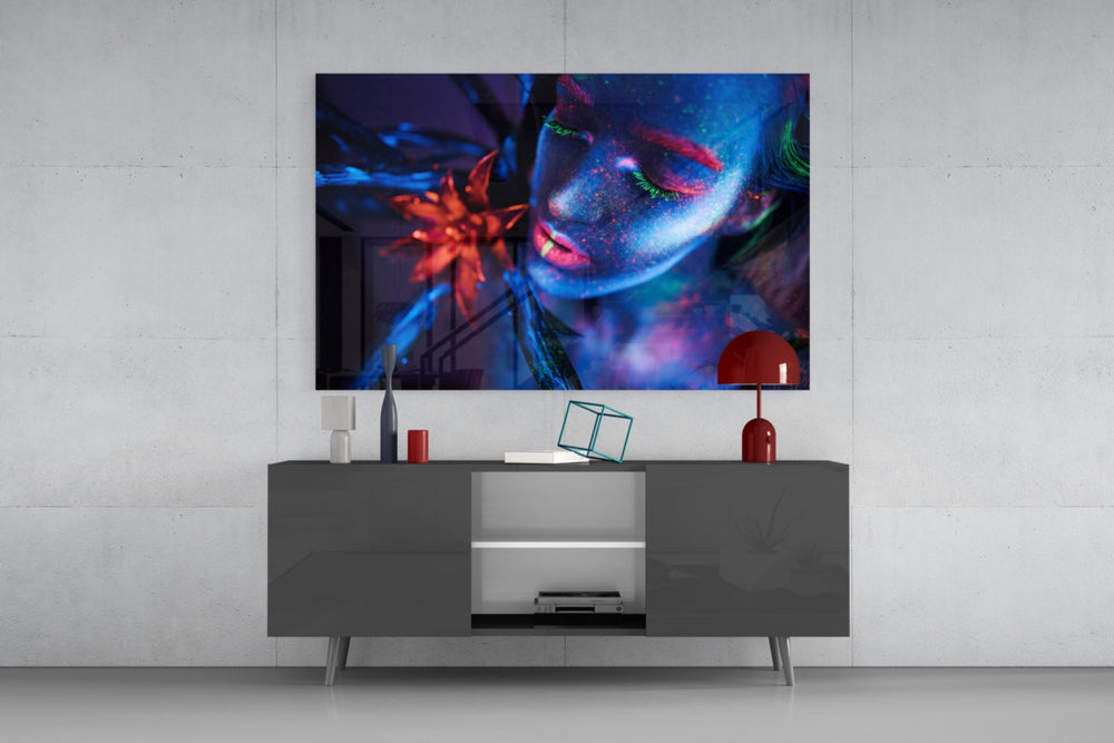 Woman glass wall art catching light to reveal its painted UV pigments