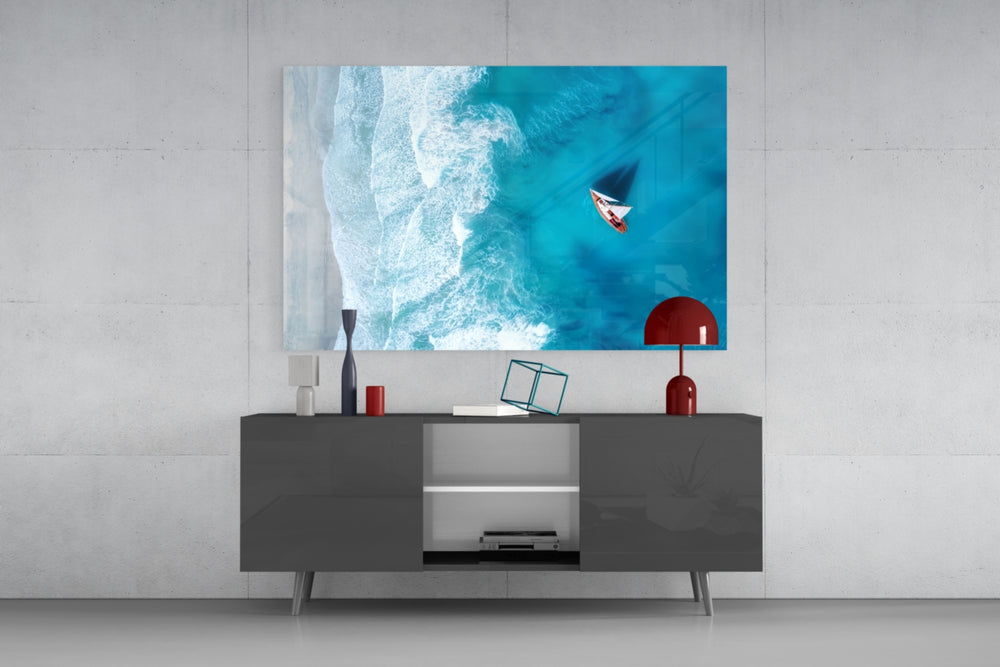 Oceanside glass wall art catching light to reveal its painted shoreline tones