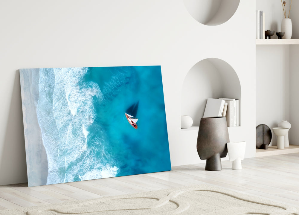 Close-up detail of sailboat and turquoise water behind glass