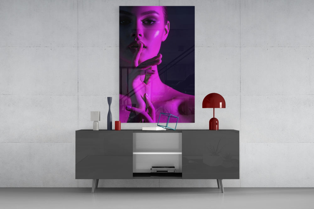 Woman glass wall art catching light to reveal its painted magenta wash