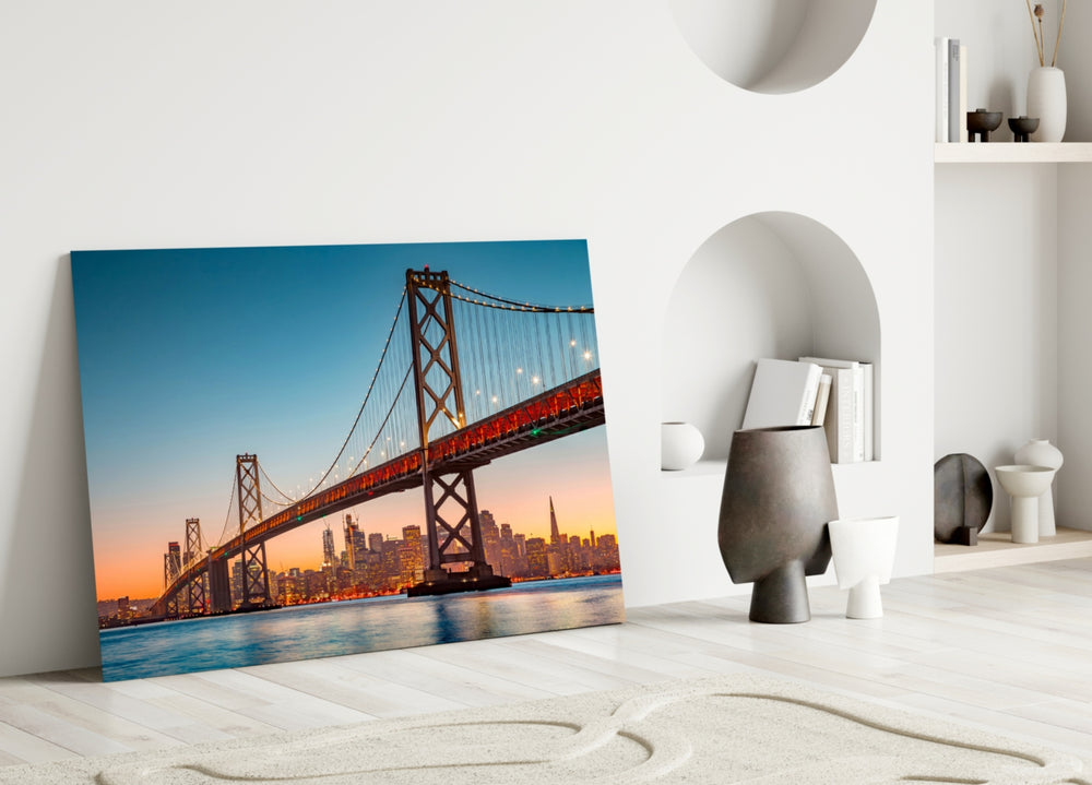 Close-up detail of suspension towers and SF skyline behind glass