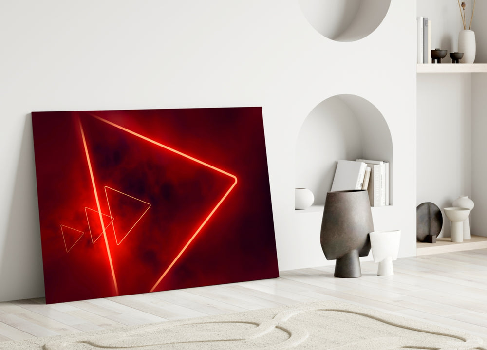 Close-up detail of scarlet neon-tube triangles behind glass