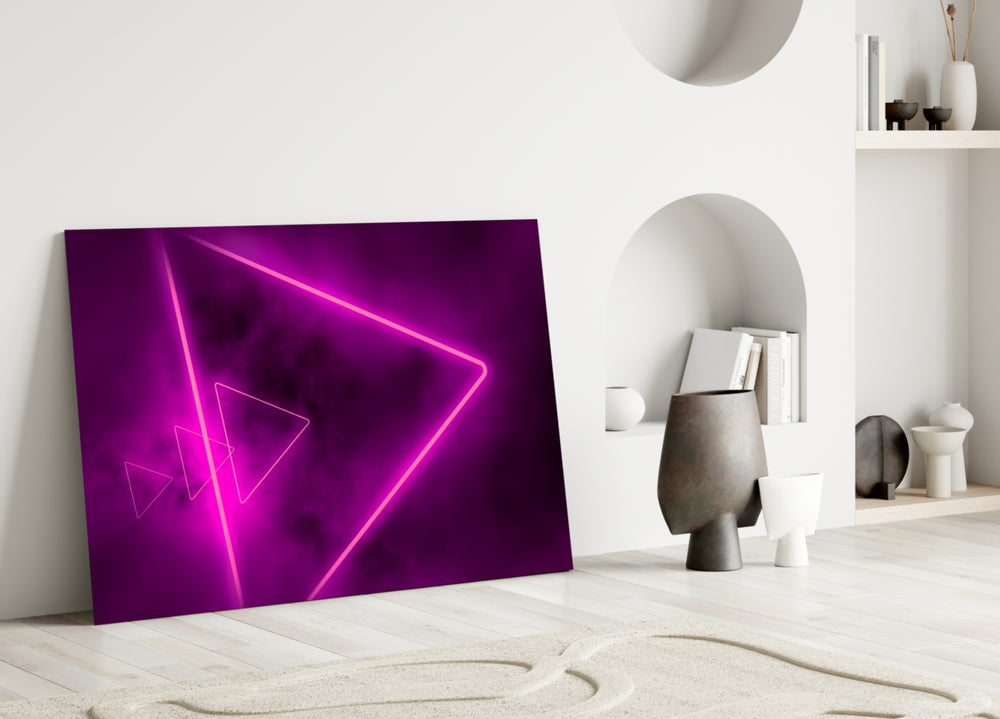 Close-up detail of magenta neon-tube triangles behind glass