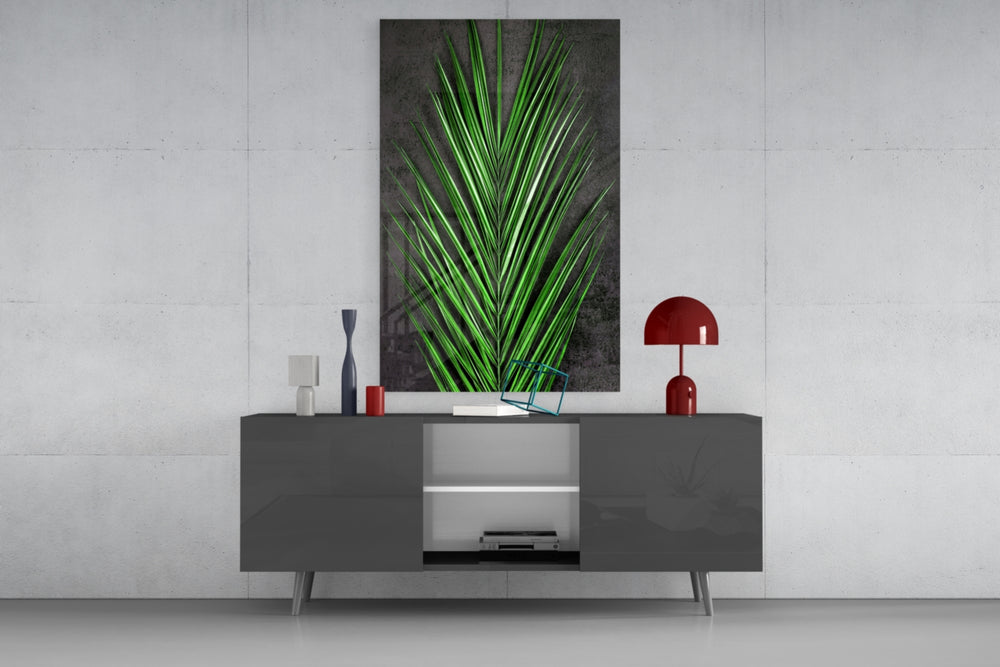Areca Bunch glass wall art catching light to reveal its painted emerald frond