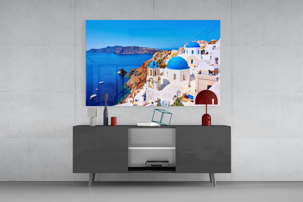 Santorini glass wall art catching light to reveal its painted blue domes