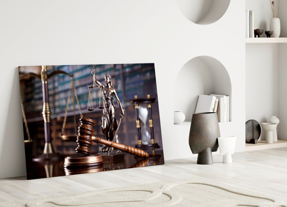 Close-up detail of walnut gavel and Lady-Justice behind glass