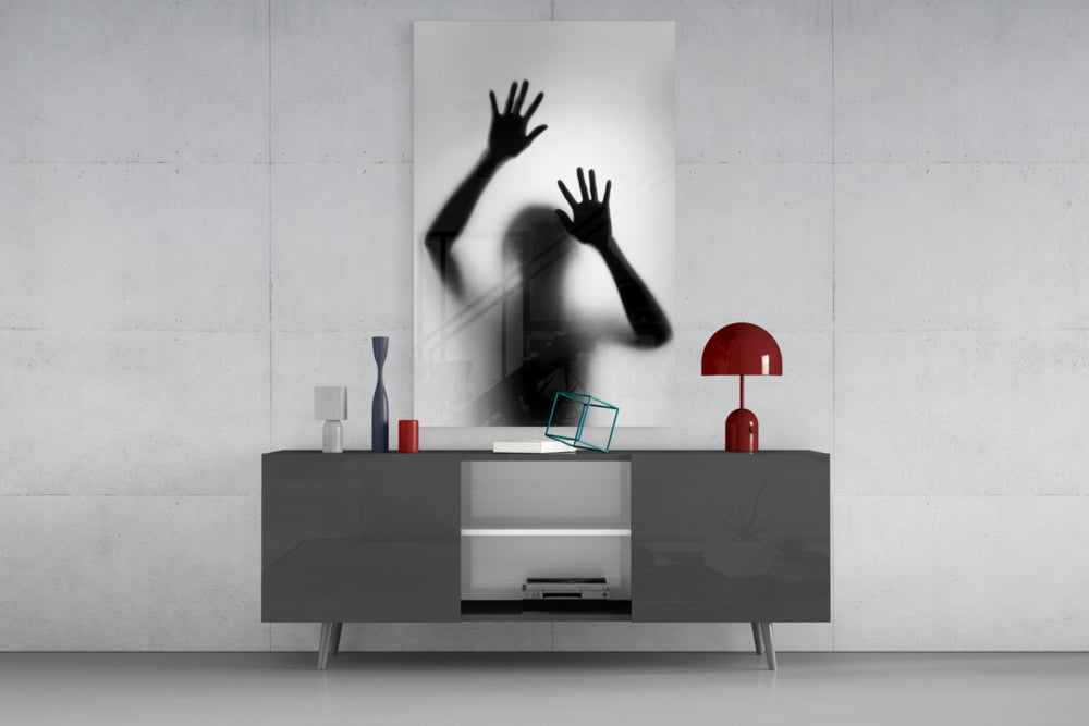 Loneliness glass wall art catching light to reveal its painted silhouette