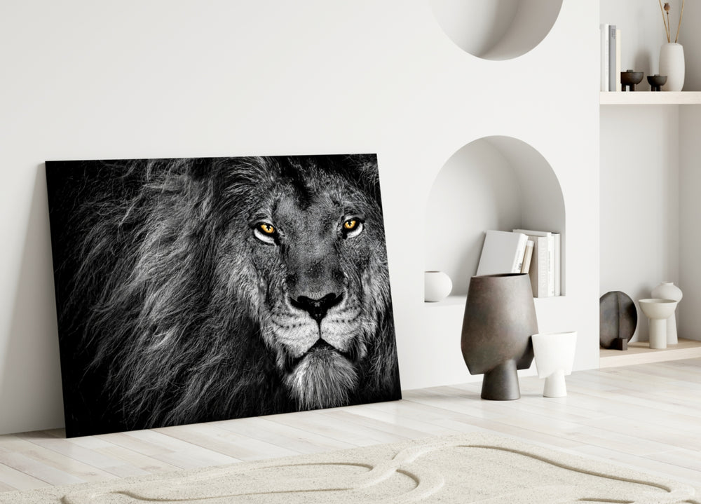 Close-up detail of monochrome lion with amber eyes behind glass