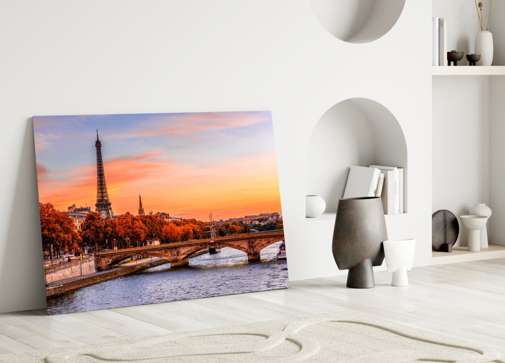 Close-up detail of Eiffel Tower and autumn-tangerine trees behind glass