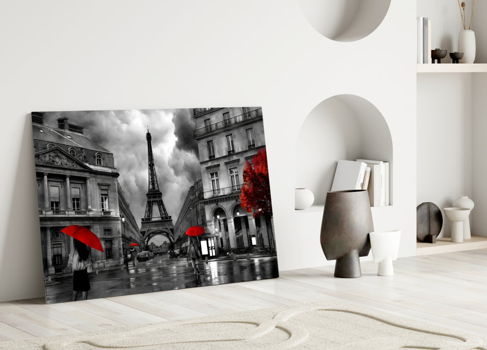 Close-up detail of scarlet umbrellas and B&W boulevard behind glass