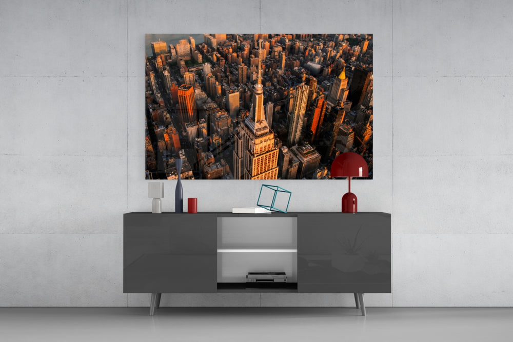 New York glass wall art catching light to reveal its painted golden-hour skyline