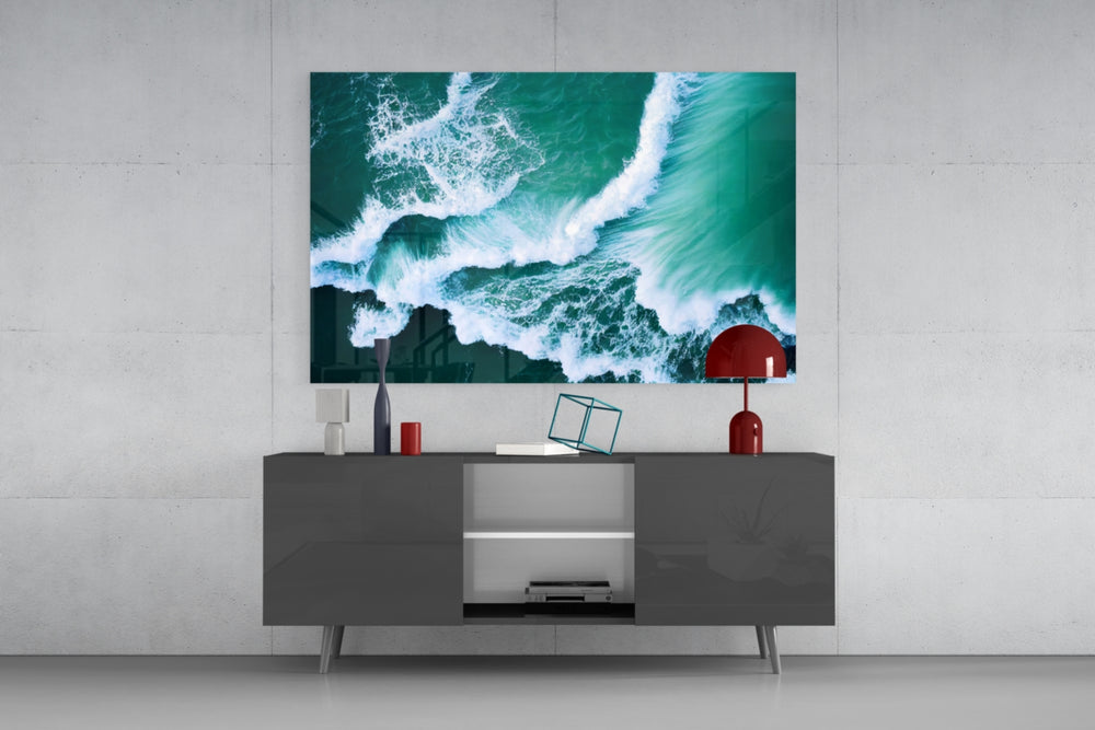Waves glass wall art catching light to reveal its painted emerald tides