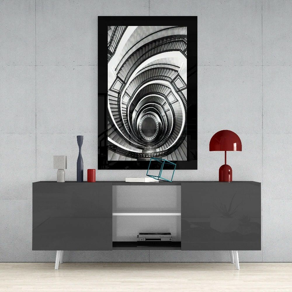 Spiral Stairs glass wall art styled above a sideboard in a stairwell