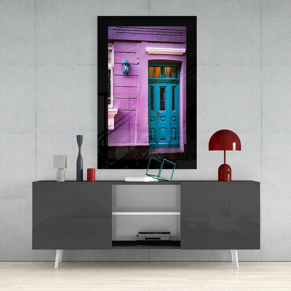 Colorful Building glass wall art styled above a sideboard in a reading nook