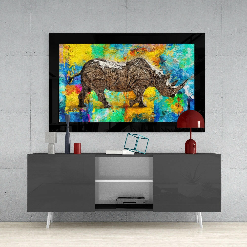 Colored Rhinoceros glass wall art styled above a console in a media room