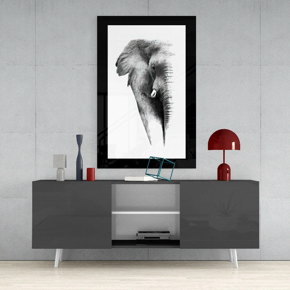 Elephant glass wall art styled above a console in a reading nook