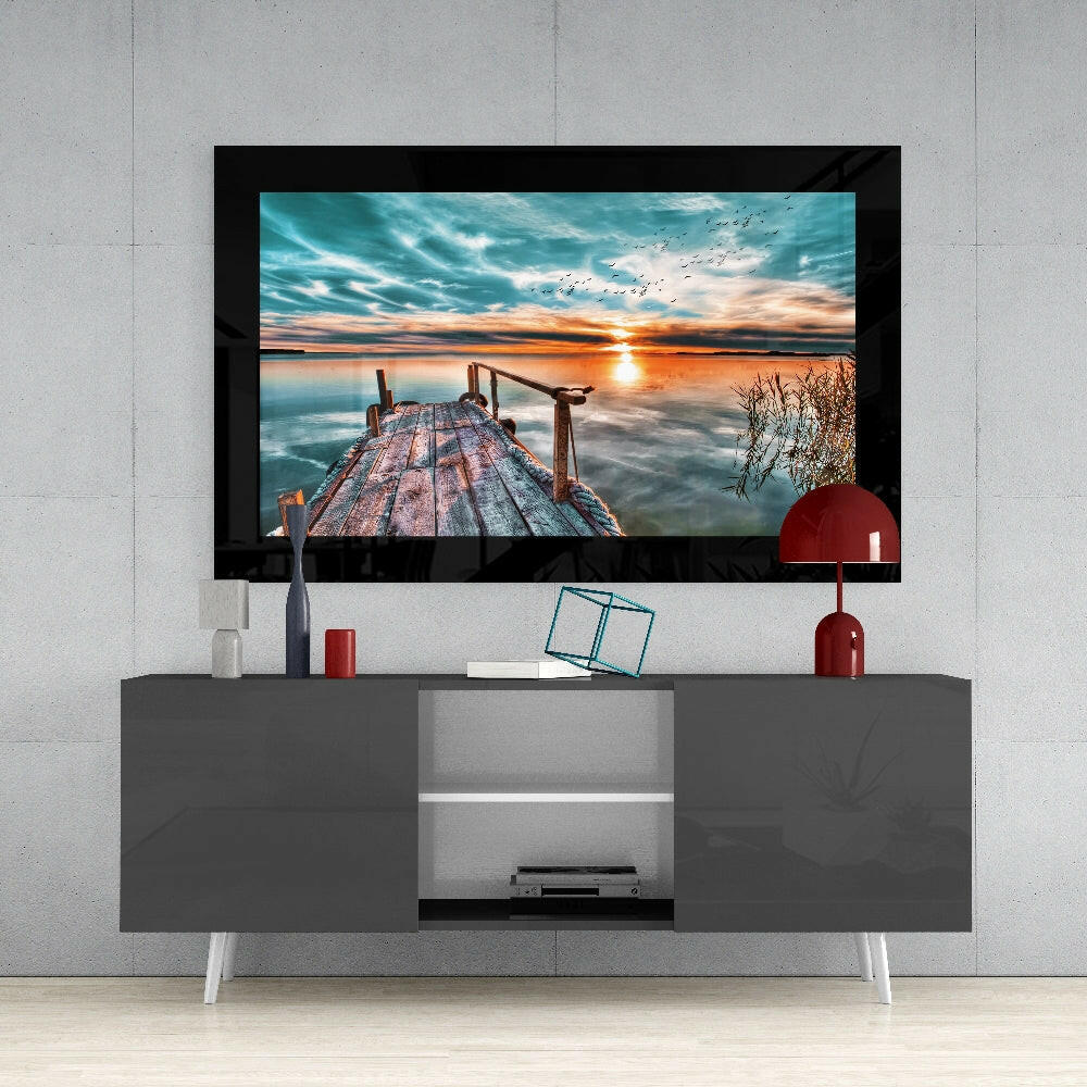 Sunset on the Dock glass wall art styled above a console in a meditation room