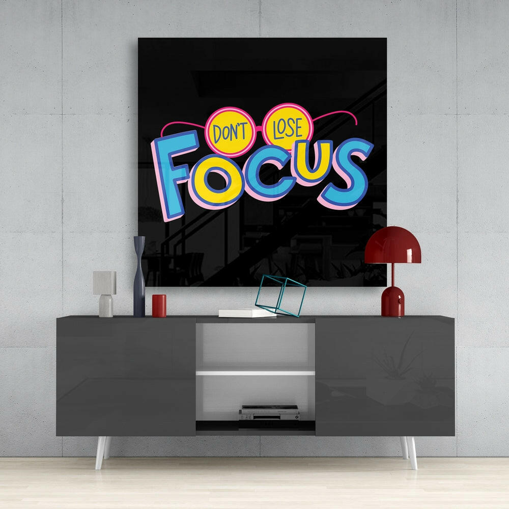 Don't Lose Focus glass wall art styled above a home-office desk as a daily reminder