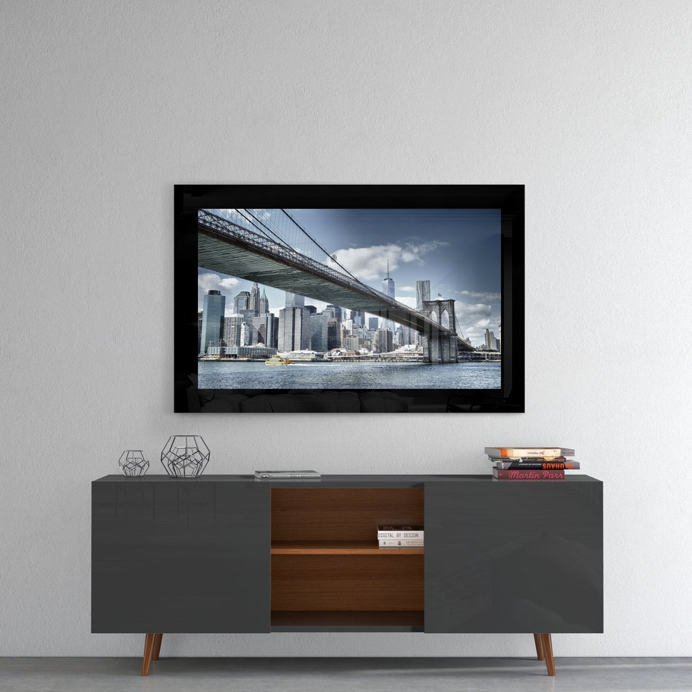Brooklyn Bridge glass wall art styled above a console in a reading nook