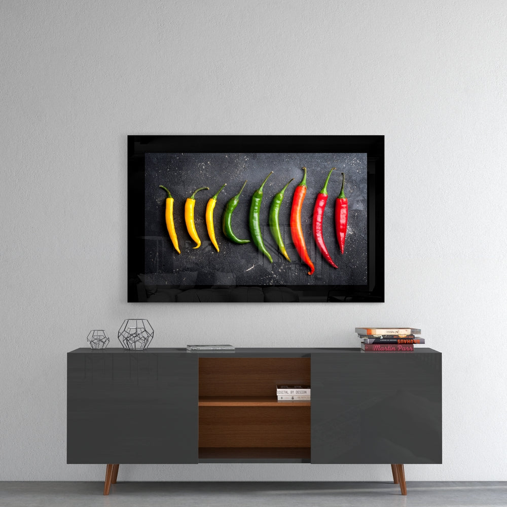 Peppers glass wall art styled above a console in a breakfast nook