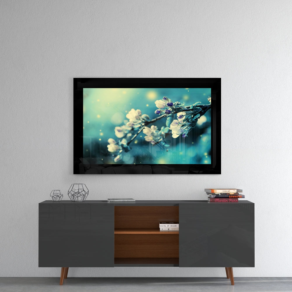 Blooming glass wall art styled above a console in a reading nook