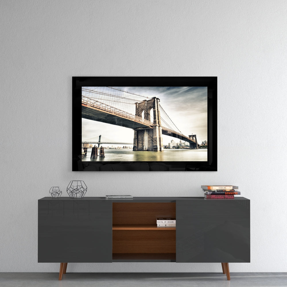 Brooklyn Bridge glass wall art styled above a console in a media room