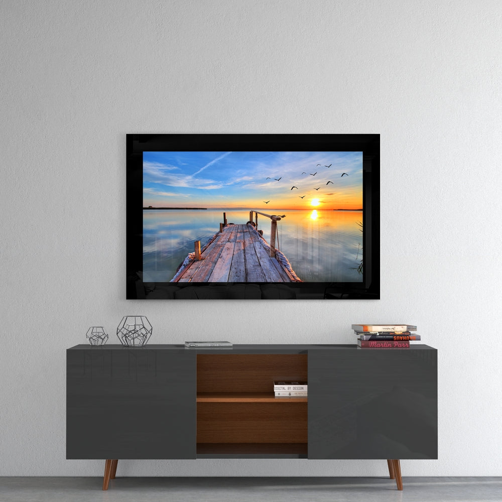 Sunset glass wall art styled above a console in a meditation room