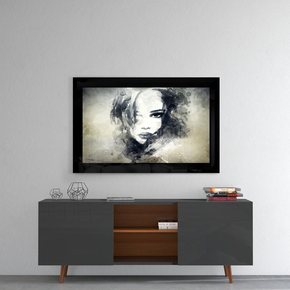 Woman glass wall art styled above a console in a creative studio